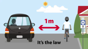 A car keeping a safe distance from a cyclist on the road