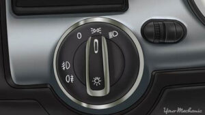 A knob on car dashboard to turn on headlights