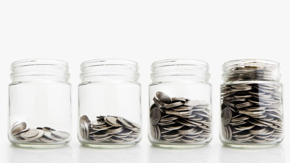 Four glass containers with coins inside
