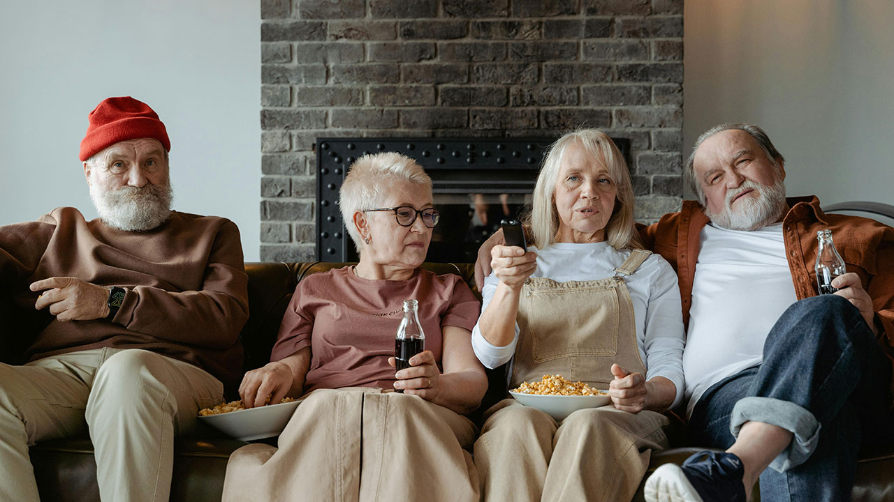 A group of older adults sitting on a couch